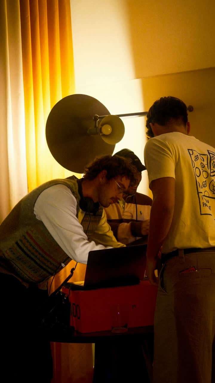 Two italø friends at the DJ decks under warm golden light