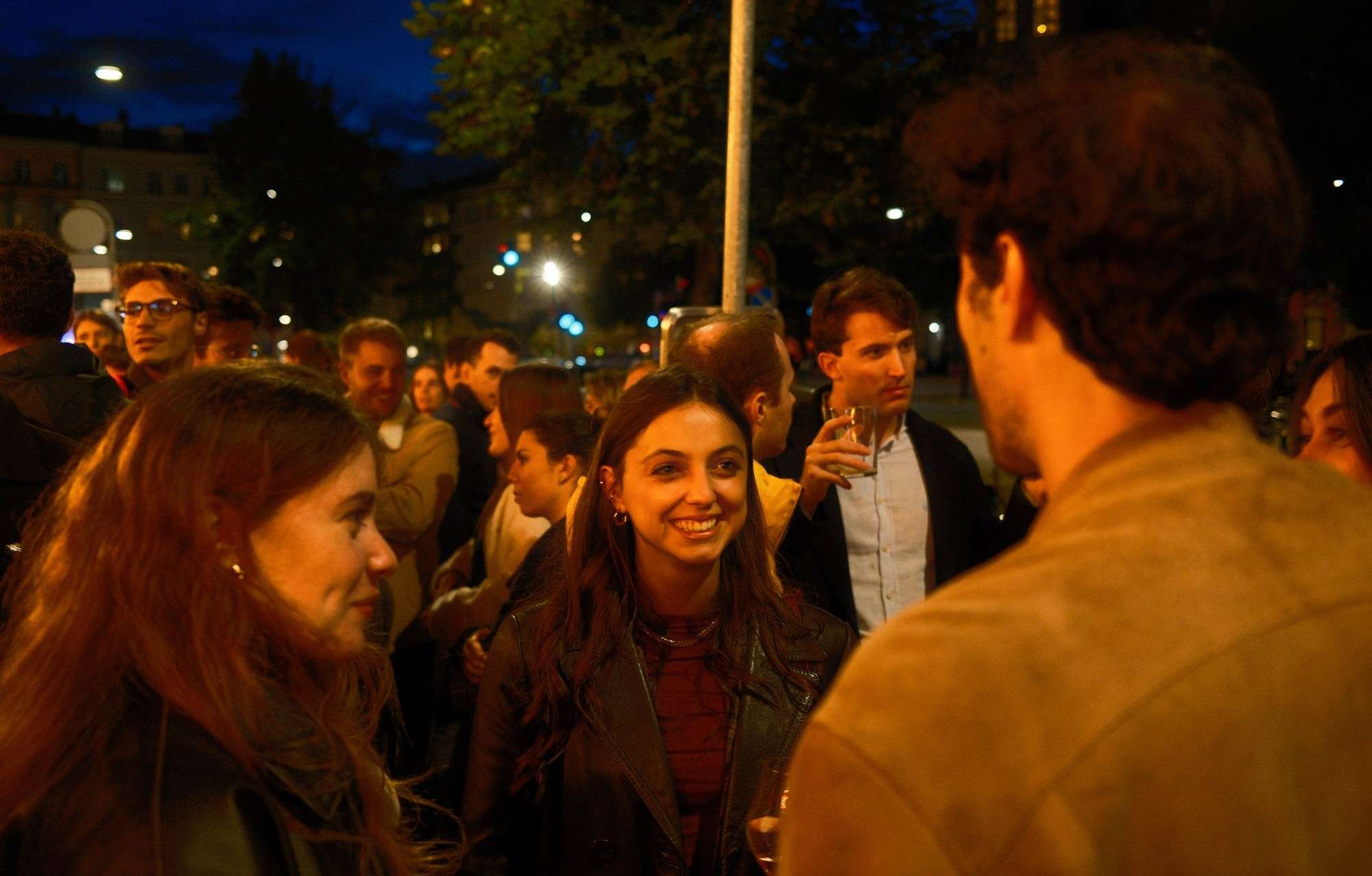 Friends talking outdoors in the evening after an italø event